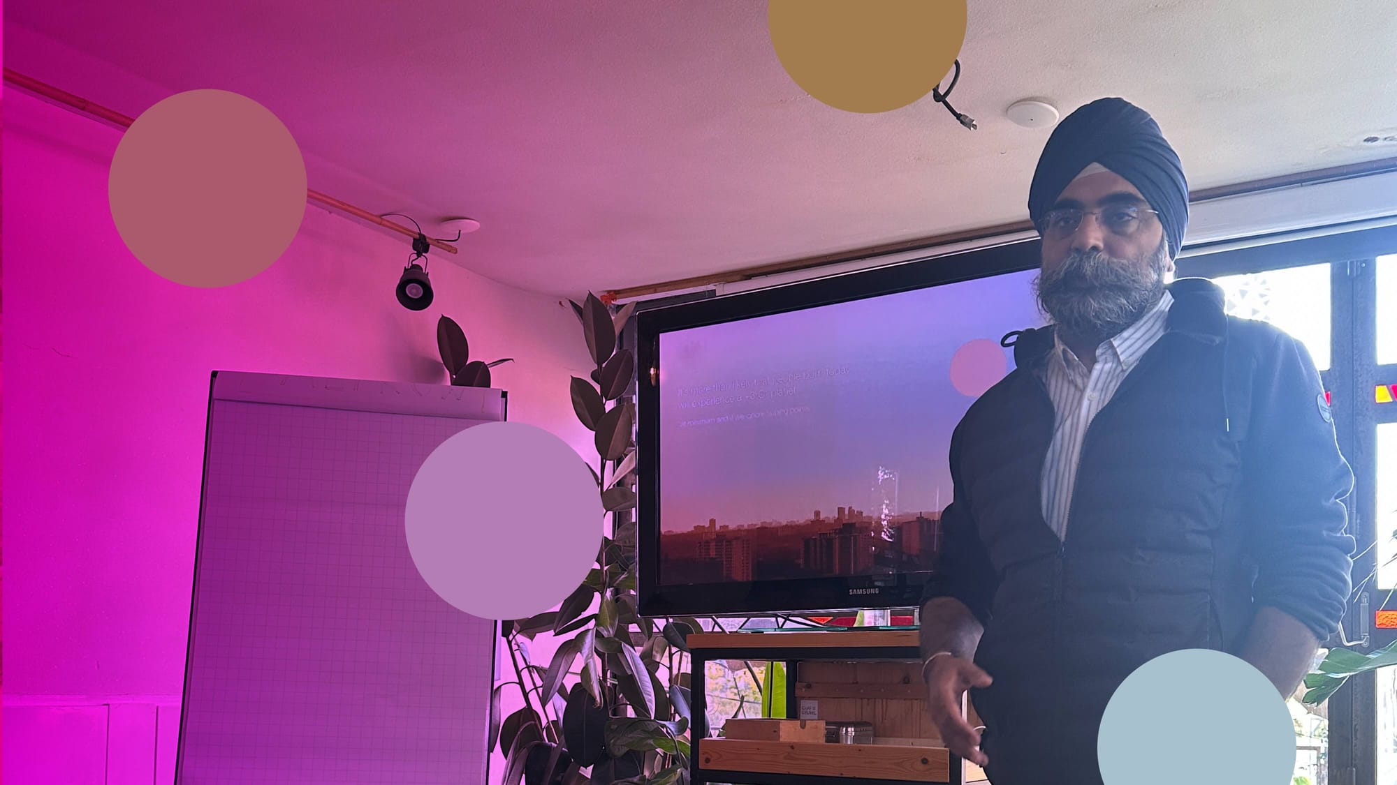 Indy Johar speaking to a seated audience inside the makeshift wooden structure at the Metabolic Lab.